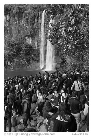 Crowd at the base of waterfall, Jeongbang Pokpo, Seogwipo. Jeju Island, South Korea (black and white)