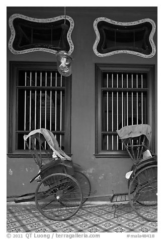 Rickshaws and windows, Cheong Fatt Tze Mansion. George Town, Penang, Malaysia