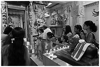 Devotees inside Tamil Nadu temple. George Town, Penang, Malaysia (black and white)
