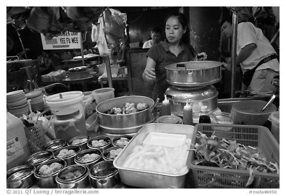 Woman serving dumplings. George Town, Penang, Malaysia