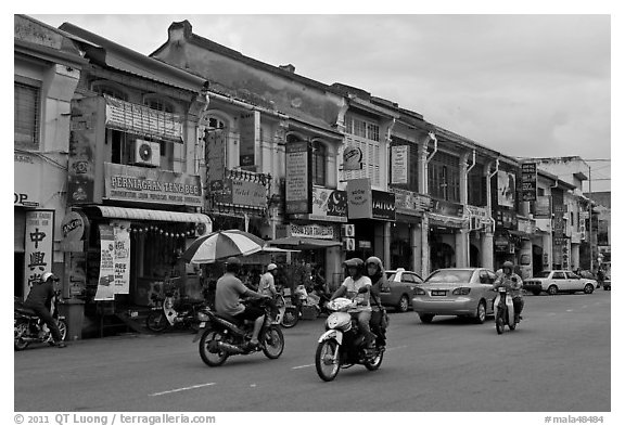 Chinatown street with traffic and storehouses. George Town, Penang, Malaysia