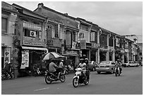 Chinatown street with traffic and storehouses. George Town, Penang, Malaysia (black and white)