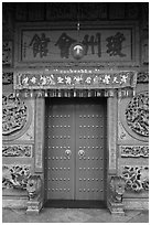 Crimson door and slate wall, Hainan Temple. George Town, Penang, Malaysia ( black and white)