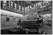 Buddha image inside Yellow Hat Buddhist temple. George Town, Penang, Malaysia (black and white)