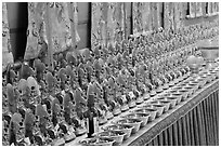 Rows of Jambhala figures, Gelugpa Buddhist Association temple. George Town, Penang, Malaysia (black and white)