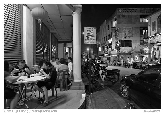 Eating on the street at night. George Town, Penang, Malaysia