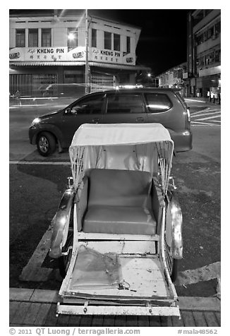 Rickshaw and auto at night. George Town, Penang, Malaysia (black and white)