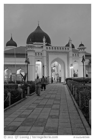 Men walking out of Masjid Kapitan Keling at dawn. George Town, Penang, Malaysia