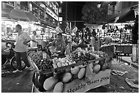 Fruit vendor pushes cart, Jalan Petaling. Kuala Lumpur, Malaysia ( black and white)