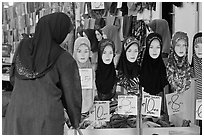 Woman in apparel store with islamic headscarves for sale. Kuala Lumpur, Malaysia ( black and white)