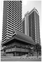Wooden traditional building at the base of high-rises. Kuala Lumpur, Malaysia ( black and white)