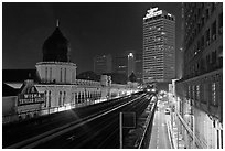 LRT train and tracks in front of Panggung Bandaraya at night. Kuala Lumpur, Malaysia (black and white)