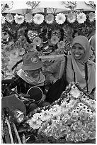 Mother and child riding decorated trishaw. Malacca City, Malaysia ( black and white)