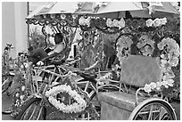 Trishaws decorated with plastic flowers. Malacca City, Malaysia (black and white)