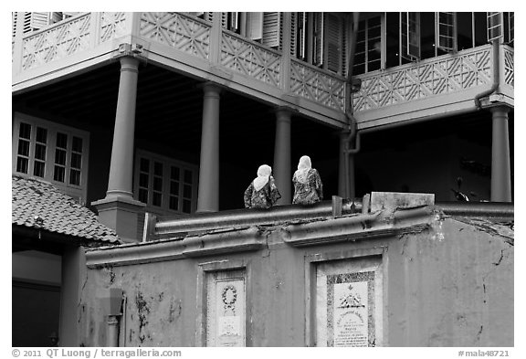 Stadthuys detail with two women. Malacca City, Malaysia