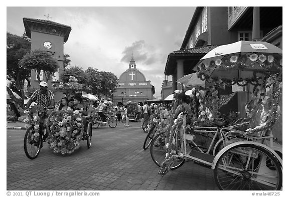 Trishaws, clock tower, and church. Malacca City, Malaysia