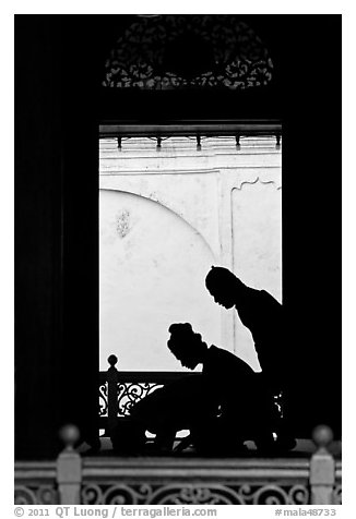 Silhouettes of men bowing in worship, Masjid Kampung Hulu. Malacca City, Malaysia (black and white)
