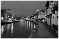 Houses and walkway at dusk, Melaka River. Malacca City, Malaysia ( black and white)