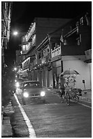 Car and bicycle rickshaw at night. Malacca City, Malaysia ( black and white)
