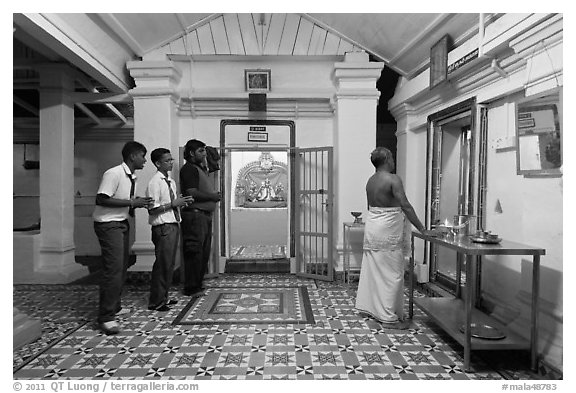 Worhipers and holy man, Sri Poyyatha Vinayagar Moorthi Temple. Malacca City, Malaysia (black and white)