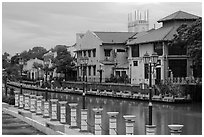 Lamps, riverside houses and St Peters Church towers. Malacca City, Malaysia ( black and white)