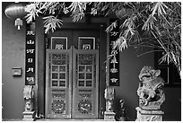 Chinese house entrance with lion sculpture and lanterns. Malacca City, Malaysia ( black and white)