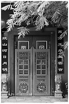 Weathered door with chinese signs and lanterns. Malacca City, Malaysia ( black and white)