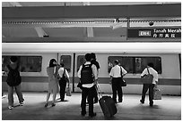 Passengers preparing to board MRT train. Singapore (black and white)