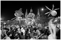 Children playing with ballons on Plaza de la Liberacion by night. Guadalajara, Jalisco, Mexico (black and white)