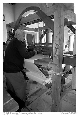 Traditional weaver and machine seen from the back, Tlaquepaque. Jalisco, Mexico (black and white)