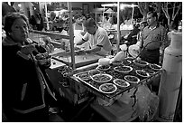 Woman eating by a street food stand , Tlaquepaque. Jalisco, Mexico ( black and white)