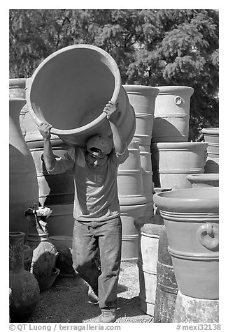 Man carrying a heavy pot, Tonala. Jalisco, Mexico