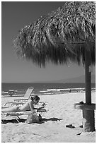 Woman in swimsuit reading on beach chair, Nuevo Vallarta, Nayarit. Jalisco, Mexico ( black and white)