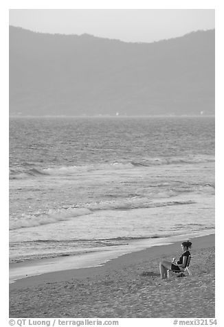 Woman sitting on the beach looking at the sunset, Nuevo Vallarta, Nayarit. Jalisco, Mexico (black and white)