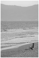 Woman sitting on the beach looking at the sunset, Nuevo Vallarta, Nayarit. Jalisco, Mexico ( black and white)