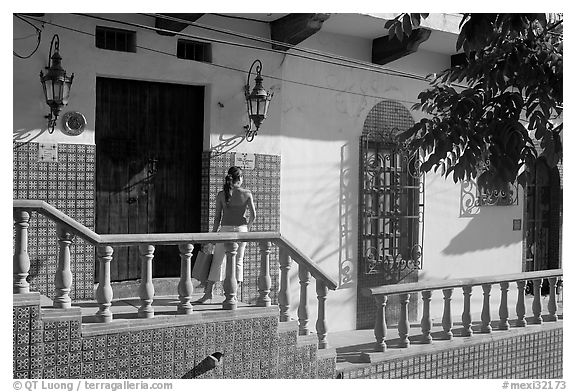 Woman waiting at the door of a house, Puerto Vallarta, Jalisco. Jalisco, Mexico (black and white)