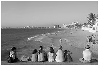 Family sitting above the beach, late afternoon, Puerto Vallarta, Jalisco. Jalisco, Mexico ( black and white)
