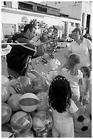 Children, mother, and balloon vendor , Puerto Vallarta, Jalisco. Jalisco, Mexico ( black and white)