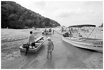 Boats moving from lagoon to ocean via small channel,  Boca de Tomatlan, Jalisco. Jalisco, Mexico ( black and white)