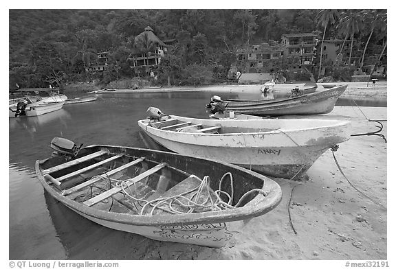 Small boats beached in a lagoon in fishing village, Boca de Tomatlan, Jalisco. Jalisco, Mexico (black and white)