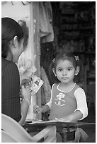 Girl playing with collages,  Boca de Tomatlan, Jalisco. Jalisco, Mexico (black and white)