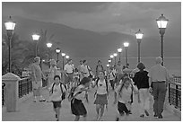 Children running on footbridge above Rio Cuale at dusk, Puerto Vallarta, Jalisco. Jalisco, Mexico (black and white)