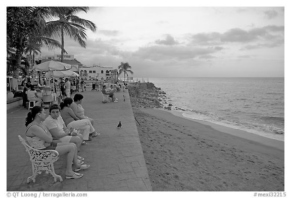Women sitting on a bench looking at the ocean, Puerto Vallarta, Jalisco. Jalisco, Mexico