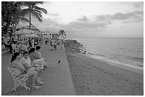 Women sitting on a bench looking at the ocean, Puerto Vallarta, Jalisco. Jalisco, Mexico ( black and white)