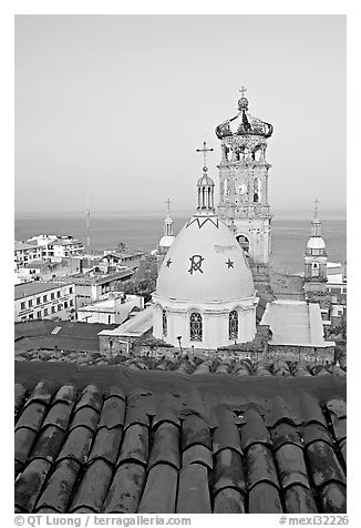 Red tile roof, Templo de Guadalupe Cathedral, and ocean early morning, Puerto Vallarta, Jalisco. Jalisco, Mexico (black and white)