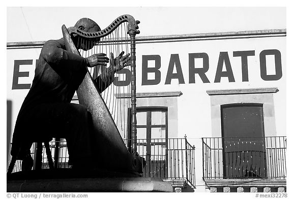 Statue of a musician and house with inscriptions. Zacatecas, Mexico
