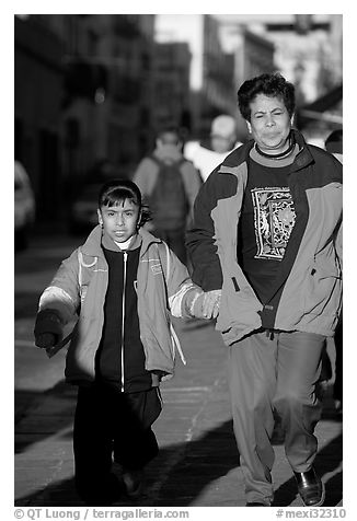 Mother and daughter on a sidewalk. Zacatecas, Mexico