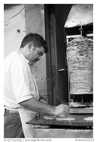 Man preparing tacos with meat. Guanajuato, Mexico (black and white)