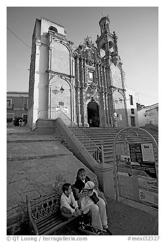 Woman and child waiting for bus below a church. Guanajuato, Mexico (black and white)