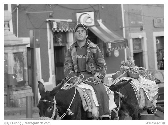 Young man riding a donkey in the streets. Guanajuato, Mexico